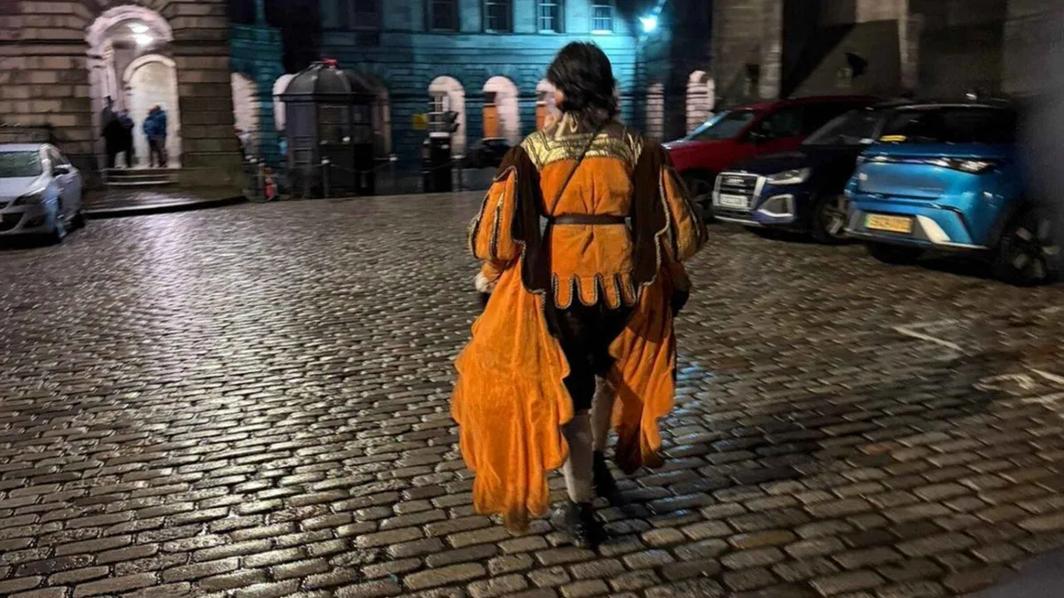 Evening group descending into the Edinburgh Vaults on an underground ghost tour of the Old Town