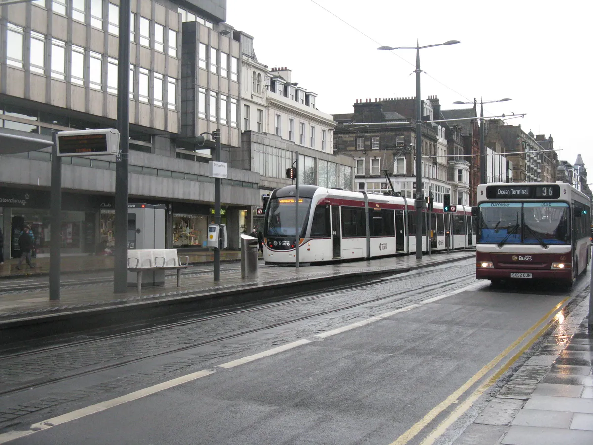 A Lothian bus and an Edinburgh tram side by side on Princes Street
